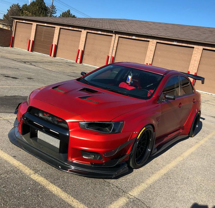 a red sports car parked in a parking lot