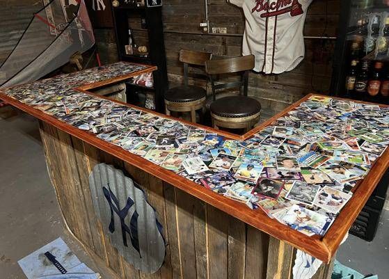 a baseball jersey is hanging on the wall next to a bar with pictures all over it