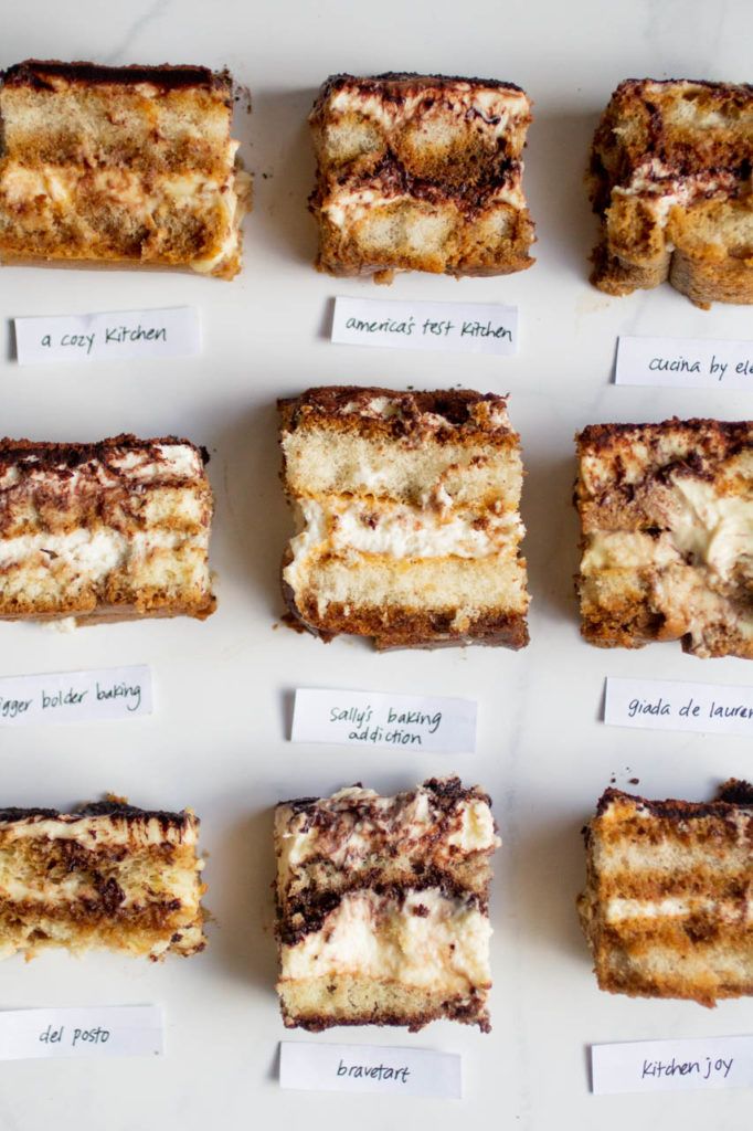 several pieces of cake sitting on top of a white tray with notes attached to it