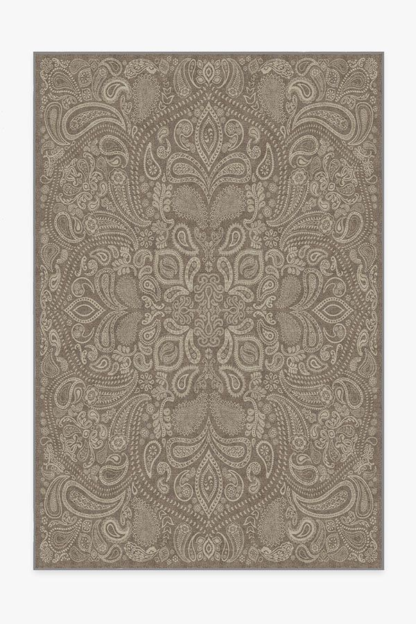 a brown and white rug with an intricate design