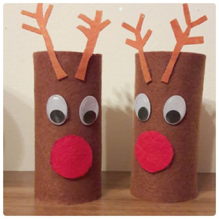 two toilet paper roll reindeers sitting on top of a wooden table