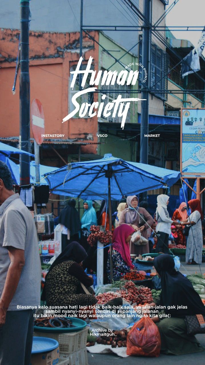 people shopping at an outdoor market with blue umbrellas in the foreground and buildings in the background