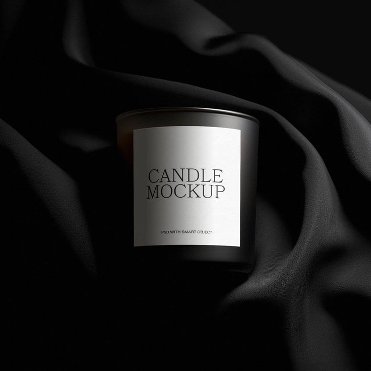 a candle that is on top of a black cloth with the words candle mockup