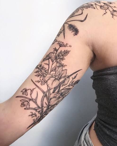 a woman with a flower tattoo on her arm