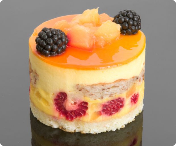 there is a cake with fruit on top and blackberries in the middle, as well as raspberries