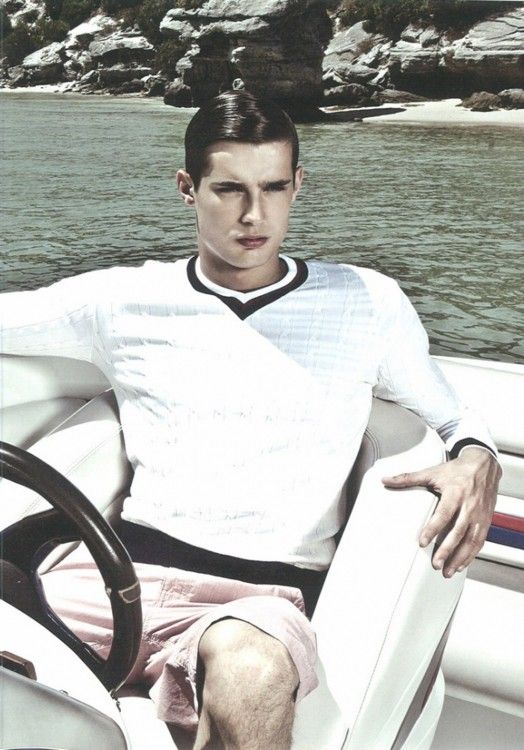 a man sitting in the driver's seat of a boat