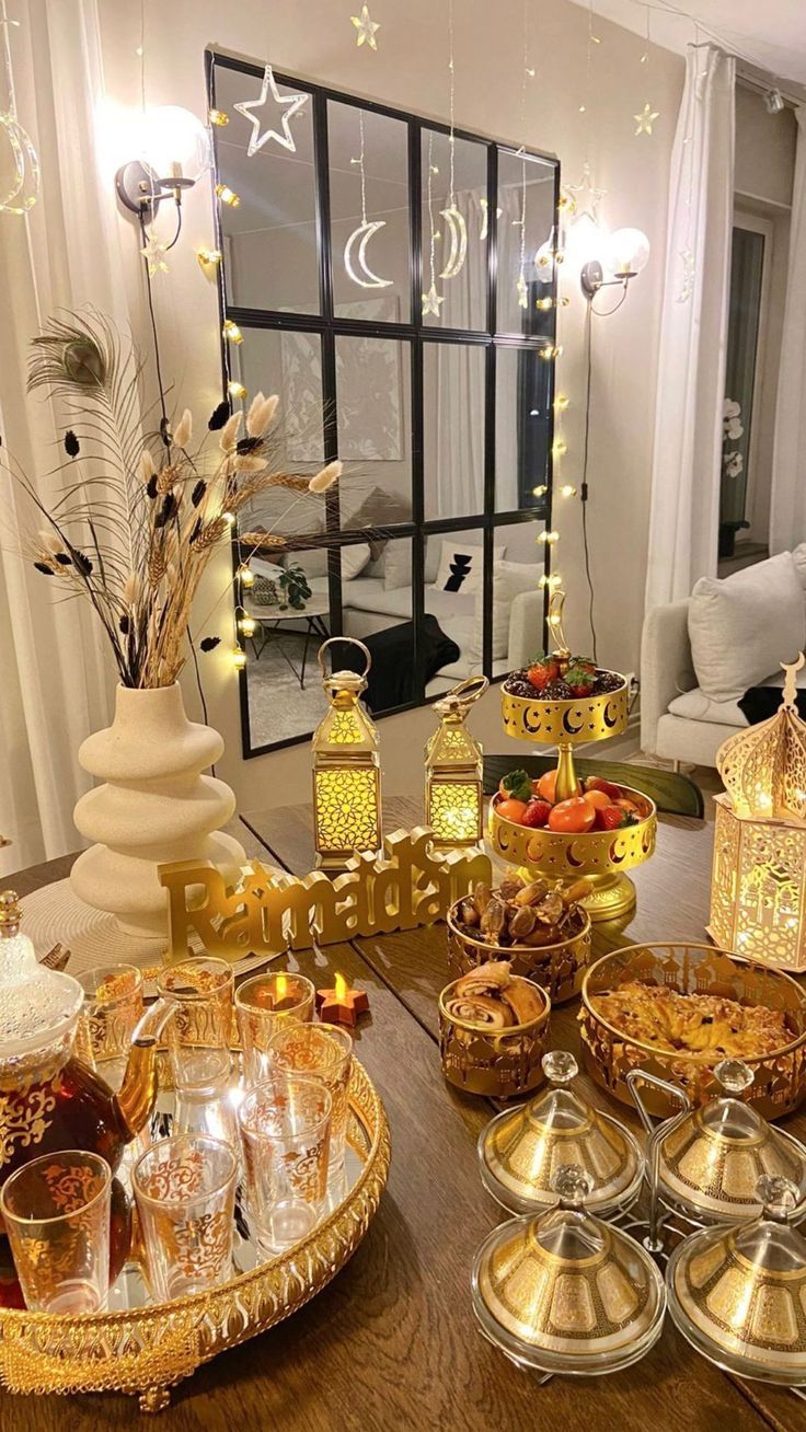 a table filled with lots of food on top of a wooden table next to a window