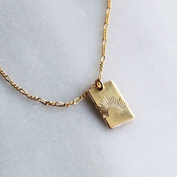 Our sun ray rectangle pendant necklace is a daily reminder to shine bright! Wear it alone or layer, it makes a great gift too! •Thick 19mm rectangle.•Choose your chain style.•100% 14kt Gold-Filled or Sterling Silver.•Stamped by hand with a sun ray Model is wearing 18 inch in photos & layered with our Unity Necklace Water friendly Rectangle Gold Necklace, Necklace Pendant Design, Minimal Gold Jewelry, Small Gold Necklace, Rectangle Pendant Necklace, 14kt Gold Jewelry, Rectangle Necklace, Preppy Jewelry, Sun Necklace