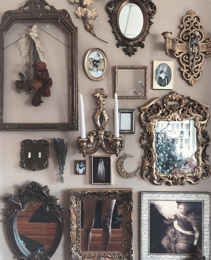 a wall filled with lots of different framed pictures and mirrors on it's side