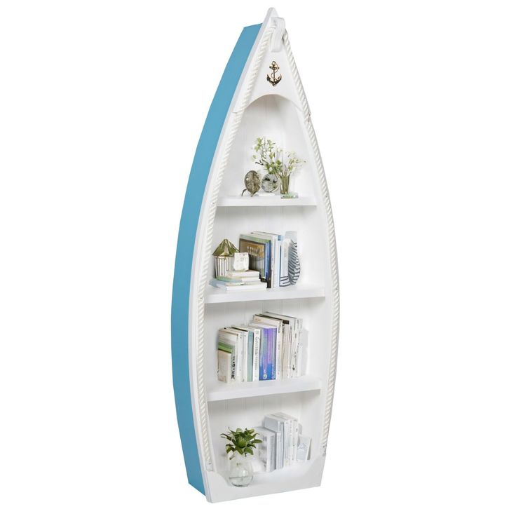 a white and blue boat shaped shelf with books on the bottom, in front of a white background