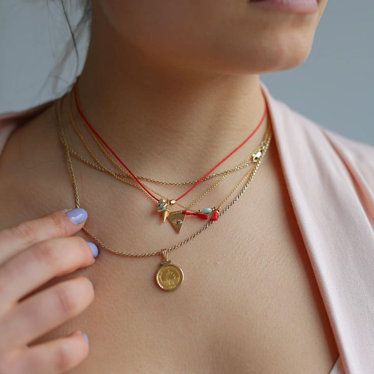 Introducing our Evil Eye Tassel Necklace, a top-seller from Sunday Forever. This must-have piece features an evil eye and small red tassel, available in either sterling silver or 14k gold filled. Wear it alone for a delicate touch or pair it with other necklaces for a layered look. It also makes for a thoughtful gift, packaged in our signature snap case and drawstring Nice Things pouch, complete with a description card. Plus, the chain can be easily adjusted from 15" to 17.5" for the perfect fit