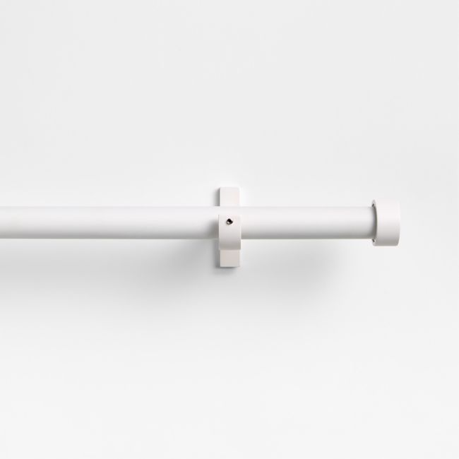 a white wall mounted light fixture on the side of a wall with an attached rod