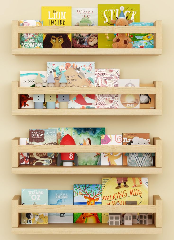 three wooden bookshelves with children's books on them