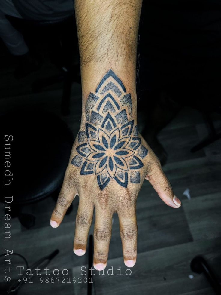 a person's hand with a tattoo on it