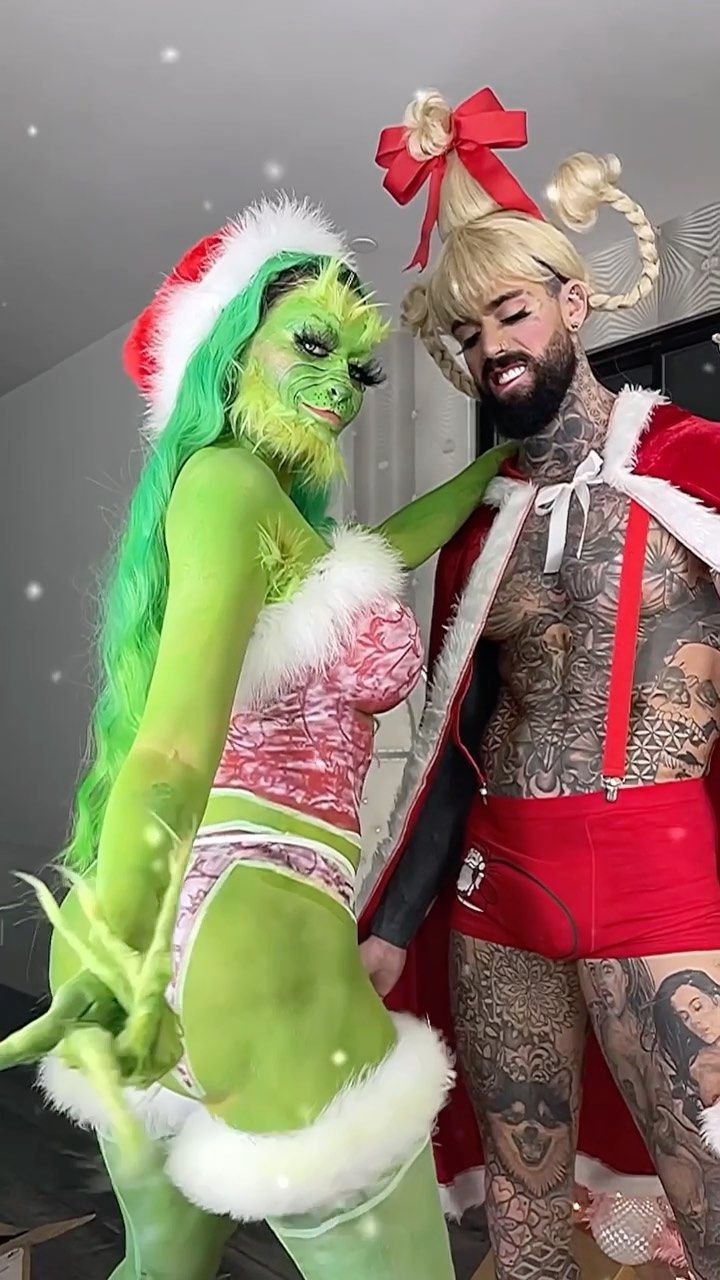 a man and woman dressed up as santa claus and the grinch are standing next to each other