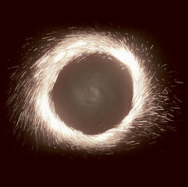 a black hole that is in the dark with some white light coming out of it