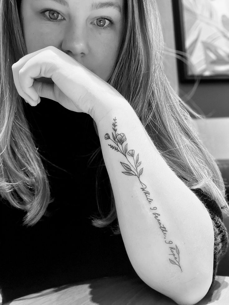 a woman with a tattoo on her arm