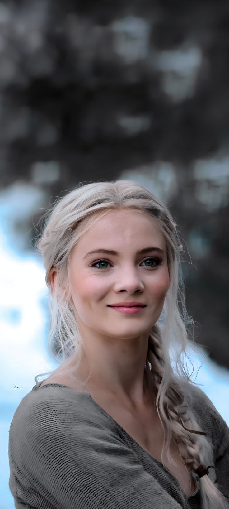 a woman with blonde hair is smiling at the camera