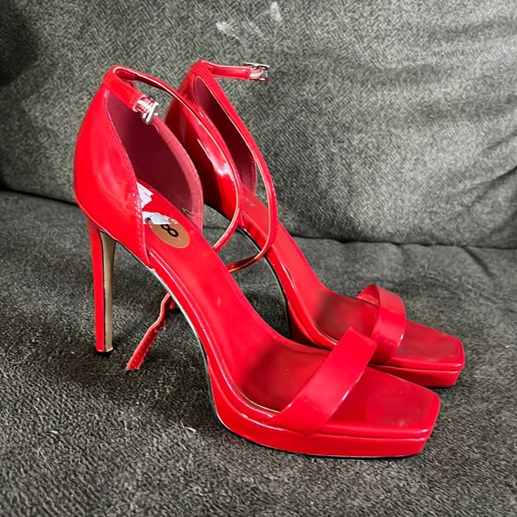 Worn Once. New Without Tags. Red Synthetic Heels With 4-inch Heel, Red Platform Heels With Open Heel, Red High Heels With Heel Strap, Red Open Heel Heels With Branded Heel Counter, Bold Red Ankle Strap Heels, Chic Red Platform Heels, Red Synthetic Open Heel Heels, Red High Heel Shoes With Branded Heel Counter, Red Open Heel Shoes With 4-inch Heel