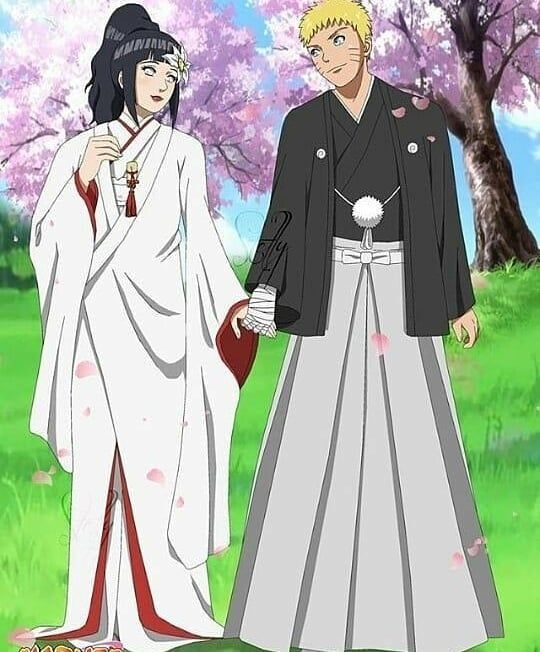 two people dressed in traditional japanese clothing standing next to each other with trees in the background