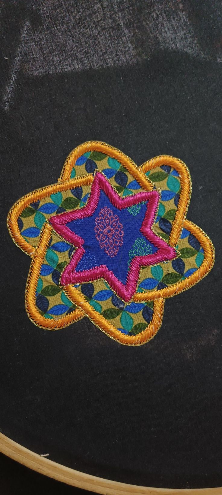 an embroidered patch with a star on it