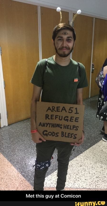 a man holding a sign that says area 51 refuge anything helps god's bees