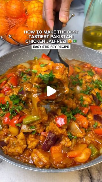 a pan filled with chicken and vegetables on top of a table