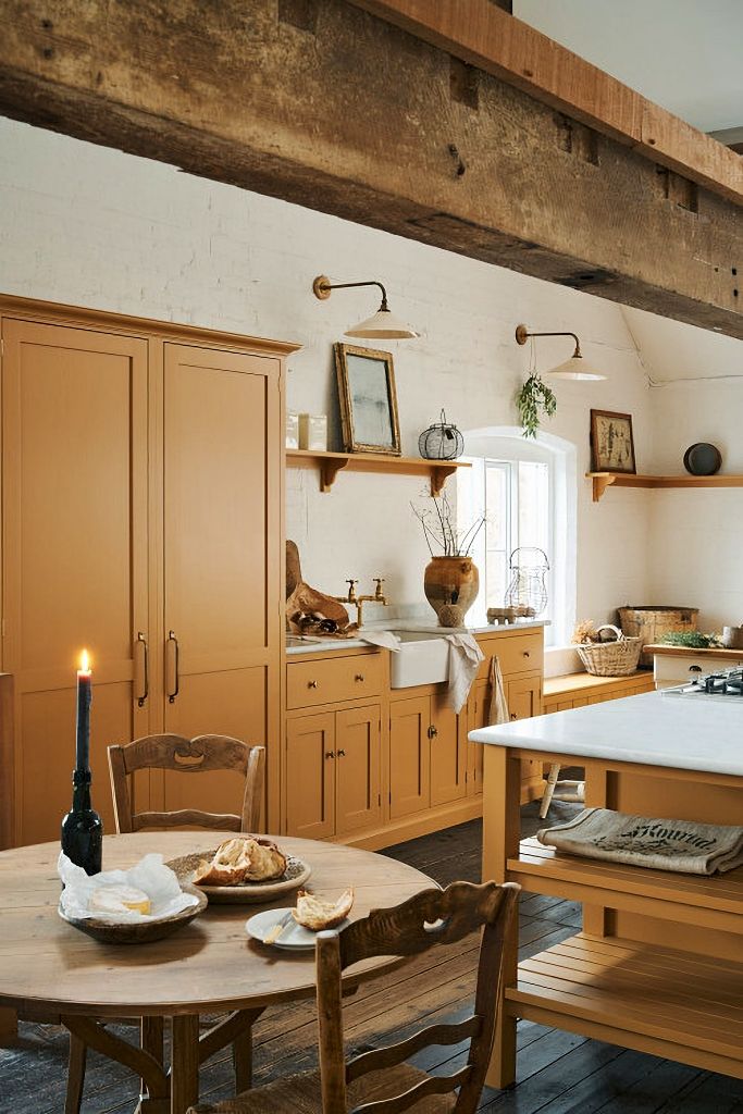 a kitchen filled with lots of wooden furniture