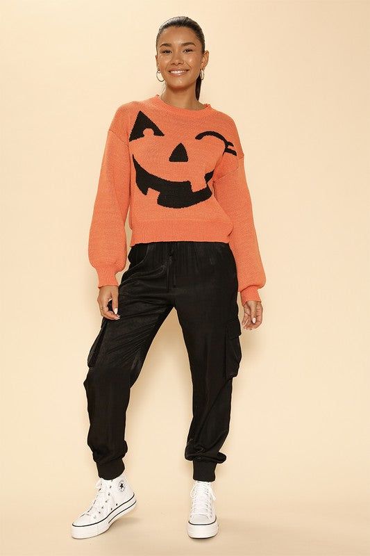 Celebrate the spooky season in style with this exclusive in-house designed Pumpkin Halloween sweater. Featuring a playful winky face in an original intarsia knit, this cozy sweater has a round neckline and a relaxed fit, perfect for casual wear or festive gatherings. Style: Casual Print / Pattern: Pumpkin Winky Face Silhouette: Sweater Fit: Regular Neck Line: Round Neck Sleeve: Long Sleeve Imported Midi Skirt And Boots, Jack Pumpkin, Winky Face, Pumpkin Sweater, Sweater Pumpkins, Novelty Sweater, Skirt And Boots, Halloween Sweater, Sweater Fits