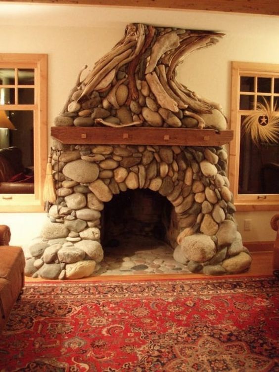 a living room with a fire place made out of rocks