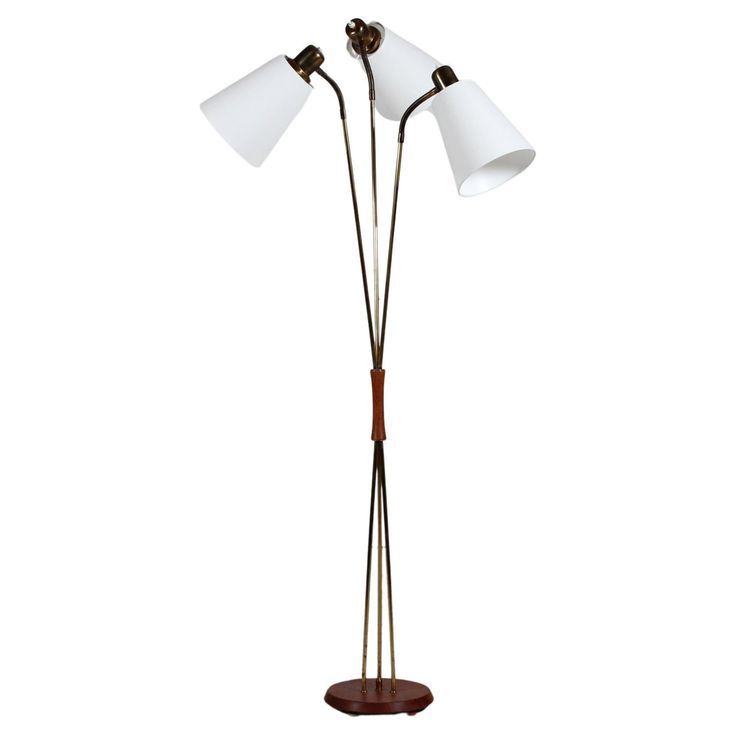 three light floor lamp with wooden base and two white shades on the lampshades