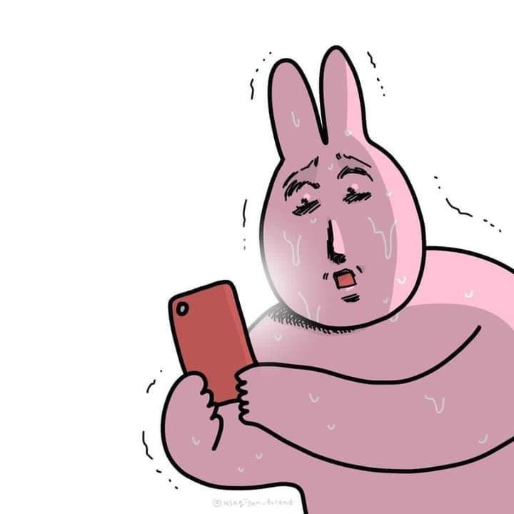 a pink bunny holding a cell phone in its right hand