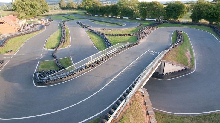 an aerial view of a race track with cars driving on it