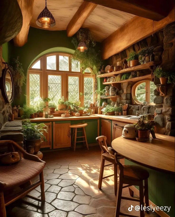 a kitchen filled with lots of potted plants next to a wooden table and chairs