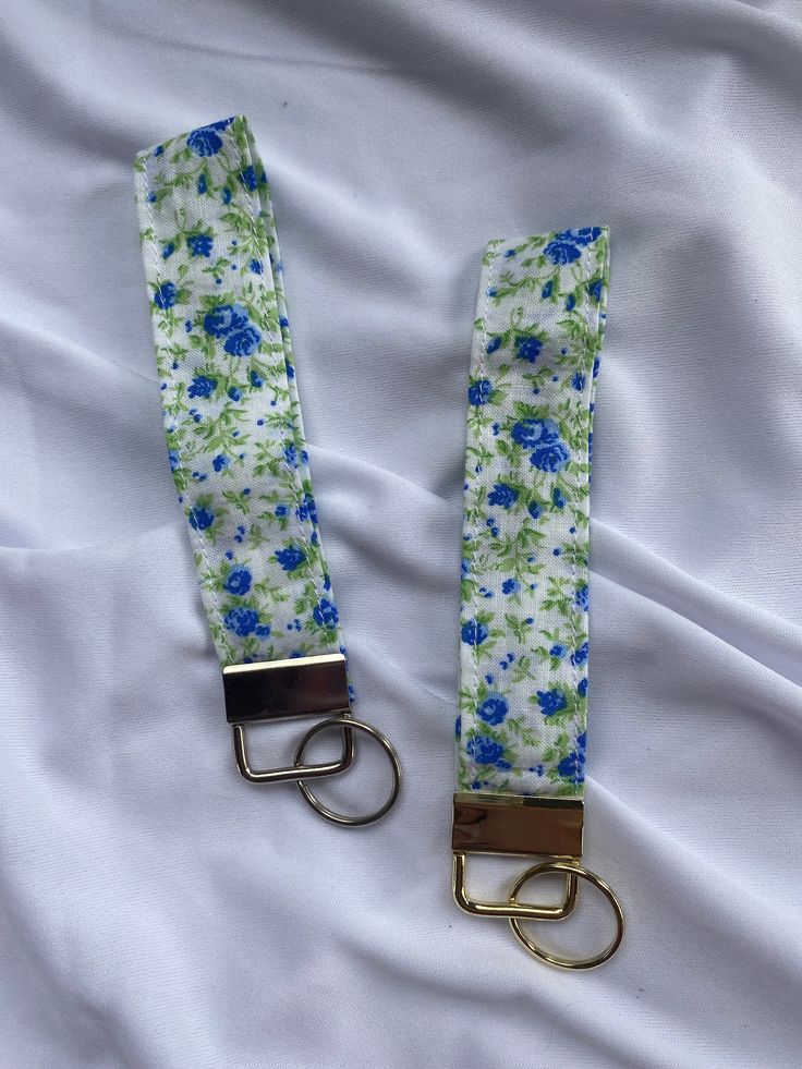 These keychain are the perfect thing to hold your keys, airpod case, or one of our keychain wallets! Mix & match with your keychain wallet to be fully customizable by you! Each strap is 1 inch wide and approximately 10 inches long (5 inches on each side).  Any questions please message me or email me at fasciaandpalla@gmail.com. Return policy can be found on my shop page. Each item is made after your order is placed to reduce waste. Shipping time can be found on each piece, but feel free to purch Keychain Wallets, Coquette Blue, Floral Keychain, Key Fob Wristlet, Key Fobs Wristlet, Keychain Wallet, Wristlet Keychain, Airpod Case, Reduce Waste