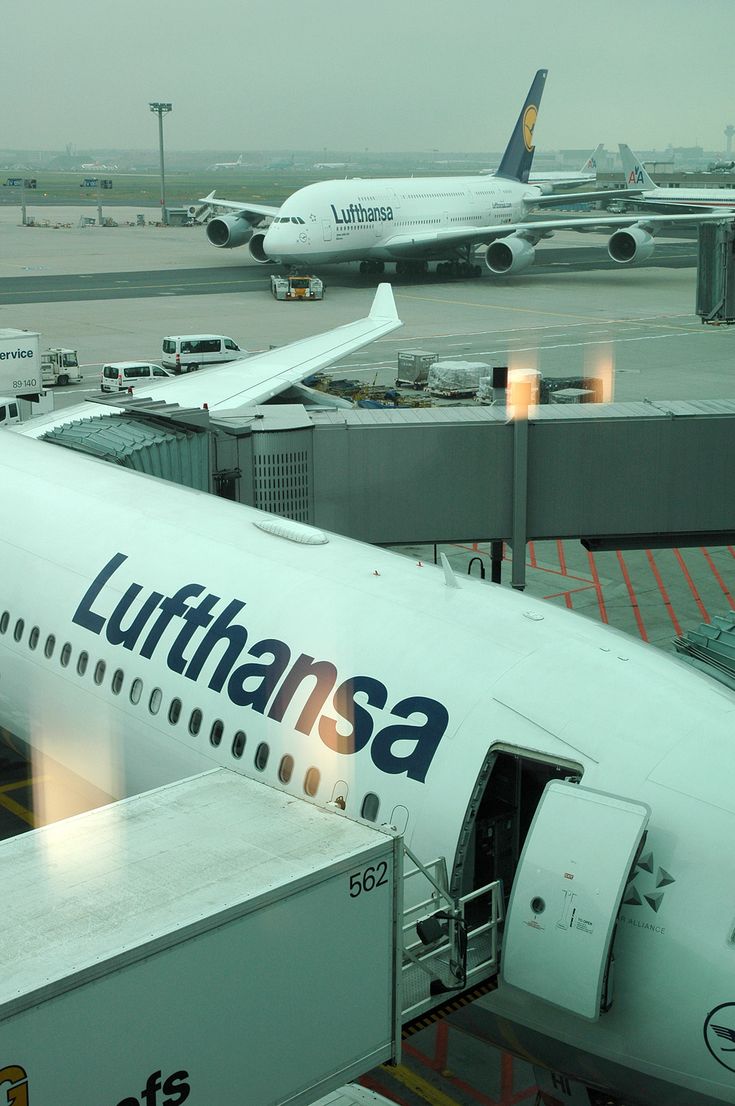 an airplane that is sitting on the tarmac with other planes in the back ground