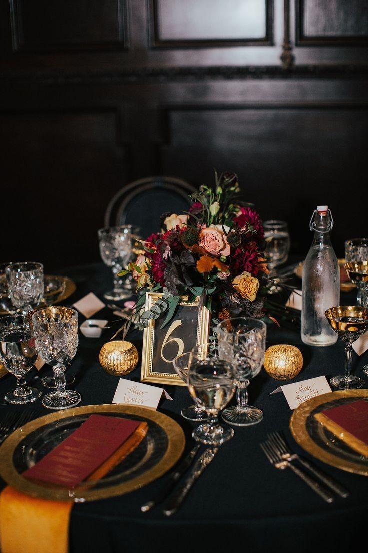 the table is set with place settings and wine glasses