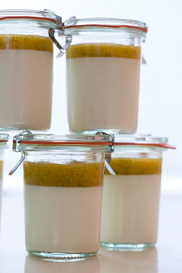 four jars filled with food sitting on top of a table