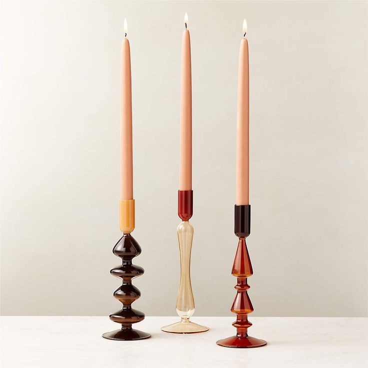 three candles sitting next to each other on top of a table