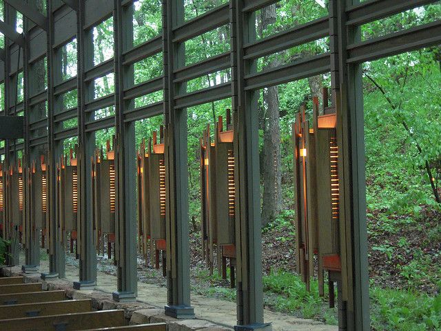 the inside of a building with stairs leading up to it and trees in the background