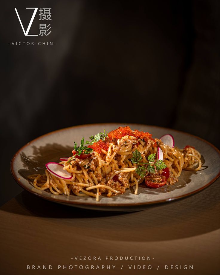 a plate filled with food on top of a wooden table next to a black wall