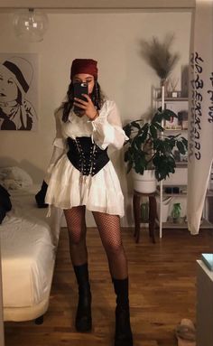 a woman is taking a selfie in her bedroom while wearing a costume and stockings