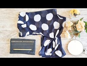 the contents of a polka dot scarf laid out on a wooden table next to flowers