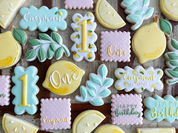 decorated cookies are arranged on a table for a one - year birthday party or baby's first birthday