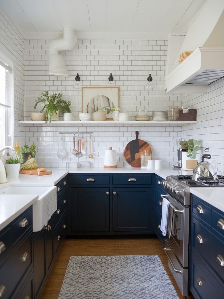 a kitchen with blue cabinets and white subway backsplash