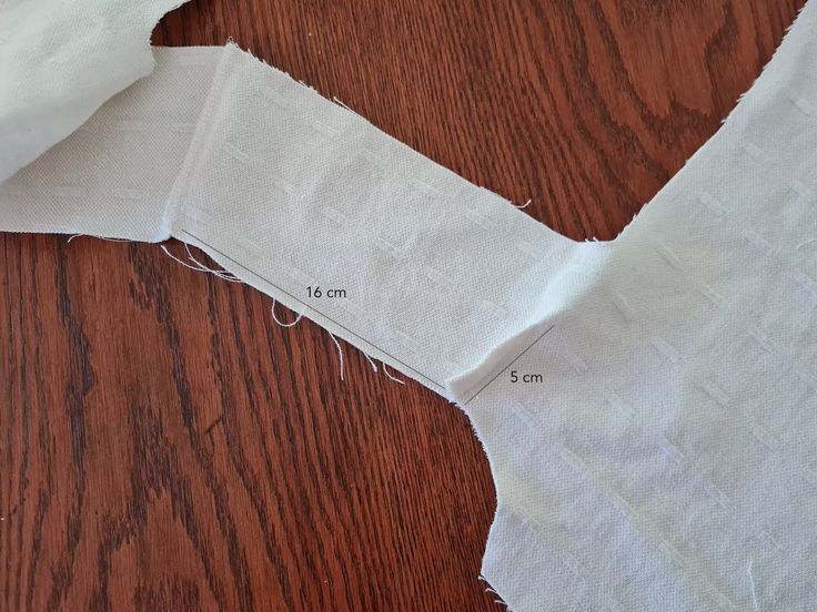 a piece of white fabric is cut into pieces