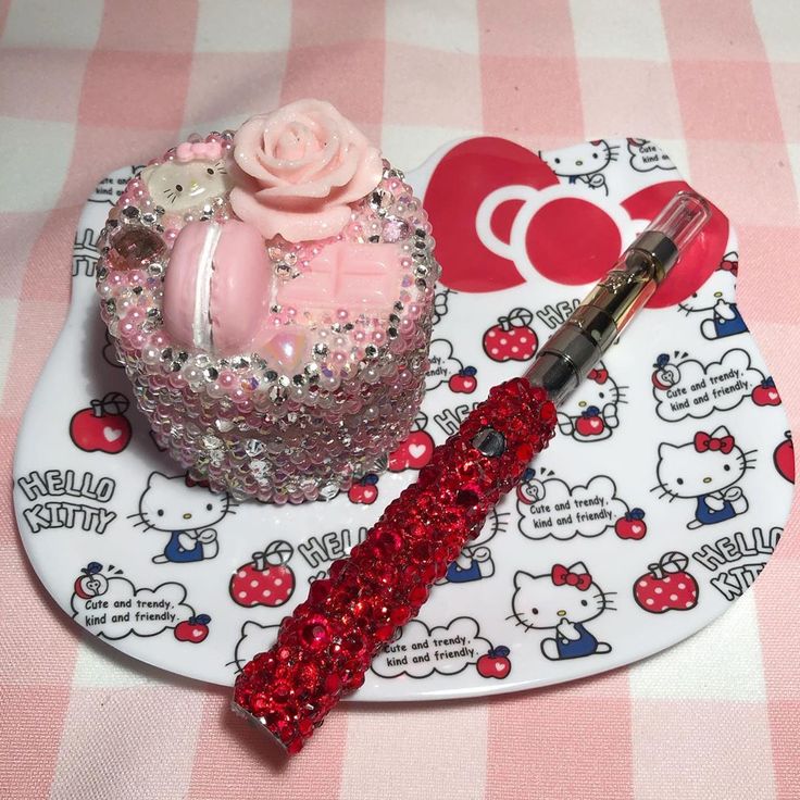 there is a hello kitty cake and brush on the plate