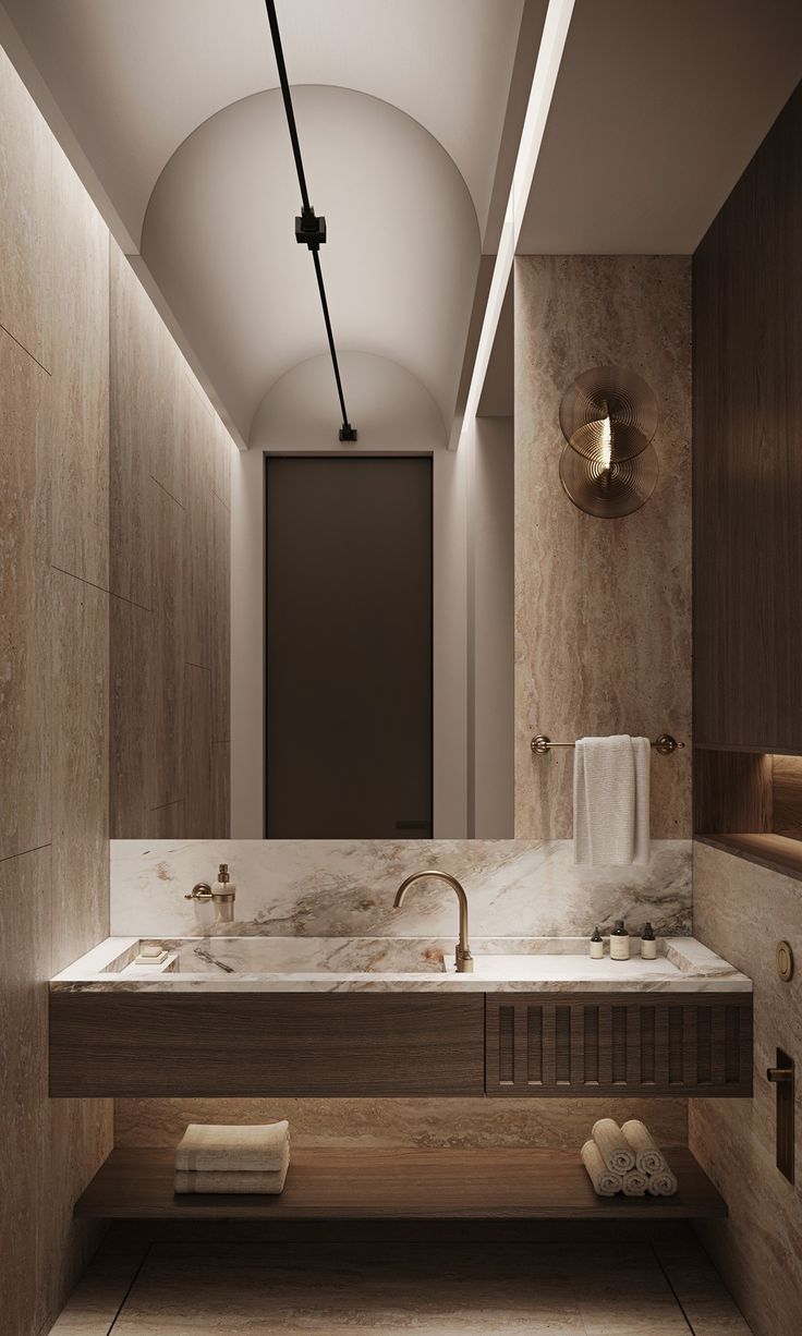 a large bathroom with two sinks and towels on the counter top in front of it