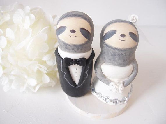 a cake topper with two slotty bears in tuxedos