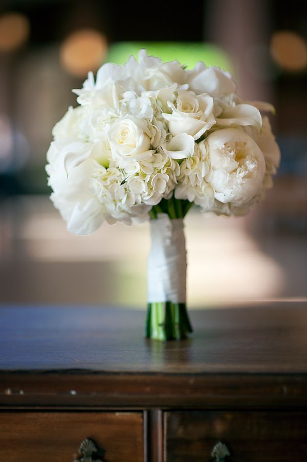 a bouquet of white flowers sitting on top of a table